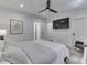 Bright main bedroom has neutral tones, ceiling fan, and seating area, with easy access to the bathroom at 14464 Gainesway Cir, Fishers, IN 46040