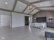 This primary bedroom features vaulted ceilings, exposed wood beams, and a sliding barn door at 14464 Gainesway Cir, Fishers, IN 46040
