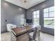 Contemporary home office with a stylish desk, large windows, and a view of the outdoors at 14464 Gainesway Cir, Fishers, IN 46040