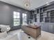 Stylish home office with custom built-ins, modern lighting, and large windows at 14464 Gainesway Cir, Fishers, IN 46040