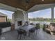 Outdoor living space with stone fireplace and views of community pond at 14464 Gainesway Cir, Fishers, IN 46040