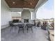 Covered patio with an stone fireplace, seating, and ceiling fan perfect for outdoor entertaining at 14464 Gainesway Cir, Fishers, IN 46040