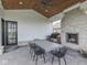 Covered outdoor space with stone fireplace and outdoor grill, great for entertaining at 14464 Gainesway Cir, Fishers, IN 46040