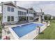 This backyard features a pristine pool, stone patio, and seamless indoor-outdoor living at 14464 Gainesway Cir, Fishers, IN 46040