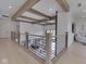The second floor has wood beams and a metal railing overlooking the dining and living areas at 14464 Gainesway Cir, Fishers, IN 46040