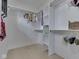 Organized walk-in closet features white shelves and rods, with clothing, storage baskets, and personal items at 14464 Gainesway Cir, Fishers, IN 46040