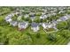 A bird's-eye view showcases the homes in a verdant, well-planned community surrounded by mature trees at 14542 Baldwin Ln, Carmel, IN 46032