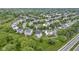 A beautifully landscaped neighborhood is captured from above, highlighting well-maintained properties and mature trees at 14542 Baldwin Ln, Carmel, IN 46032