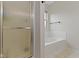 Bathroom featuring a shower with glass doors, a soaking tub, and neutral color palette at 14542 Baldwin Ln, Carmel, IN 46032