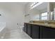 Bathroom featuring a double sink vanity, granite countertops, and modern fixtures at 14542 Baldwin Ln, Carmel, IN 46032