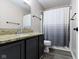 Bathroom featuring a granite countertop, dark wood cabinets, and a shower with a curtain at 14542 Baldwin Ln, Carmel, IN 46032