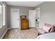 Bedroom with wood floors, natural light, and a view into an open hallway at 14542 Baldwin Ln, Carmel, IN 46032