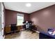 A cozy room with brown walls features a window providing natural light at 14542 Baldwin Ln, Carmel, IN 46032
