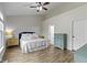 Bright bedroom with luxury vinyl plank floors, and a bed with white comforter and blue headboard at 14542 Baldwin Ln, Carmel, IN 46032