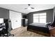 This bedroom features a window, a ceiling fan, and is equipped with a gaming setup at 14542 Baldwin Ln, Carmel, IN 46032