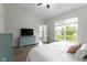 Bright bedroom featuring a large window, luxury vinyl plank floors, and TV atop the dresser at 14542 Baldwin Ln, Carmel, IN 46032
