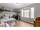 Bedroom features neutral-colored walls, wood floors, and natural light from windows at 14542 Baldwin Ln, Carmel, IN 46032