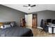Bedroom with dark grey walls features a ceiling fan and gaming setup at 14542 Baldwin Ln, Carmel, IN 46032