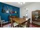 Cozy dining area features a wood table, eclectic decor, and ample natural light from the large window at 14542 Baldwin Ln, Carmel, IN 46032