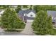Charming two-story home featuring brick accents and a well-manicured lawn surrounded by mature trees at 14542 Baldwin Ln, Carmel, IN 46032