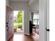 Welcoming entryway with hardwood floors leading to a living area, showcasing a bright and airy atmosphere at 14542 Baldwin Ln, Carmel, IN 46032
