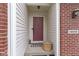 Inviting front entry featuring a covered porch, brick accents, and a decorative door with stylish accents at 14542 Baldwin Ln, Carmel, IN 46032
