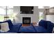 Cozy living room showcasing a comfortable blue sectional sofa and a classic fireplace at 14542 Baldwin Ln, Carmel, IN 46032