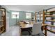 Home office featuring natural light, ample shelving, and functional furniture with a comfortable chair at 14542 Baldwin Ln, Carmel, IN 46032