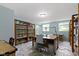 The well-lit home office features soft blue walls, neat storage solutions, and a functional workspace at 14542 Baldwin Ln, Carmel, IN 46032