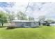 Spacious backyard featuring a well-maintained lawn and the home's light-green siding at 156 N Eastern Village Dr, Greenfield, IN 46140