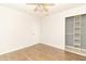 A bedroom with a ceiling fan, wood-look flooring, and a door leading to a closet at 156 N Eastern Village Dr, Greenfield, IN 46140