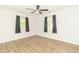 Spacious bedroom featuring a ceiling fan, hardwood floors, and natural light at 156 N Eastern Village Dr, Greenfield, IN 46140
