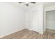 A simple bedroom design includes a ceiling fan, a large closet, and light wood flooring at 156 N Eastern Village Dr, Greenfield, IN 46140
