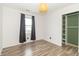 Charming bedroom with wood floors, a modern light fixture, and a closet with built-in shelving at 156 N Eastern Village Dr, Greenfield, IN 46140
