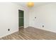 Clean, minimalist bedroom featuring wood-look floors, closet, and a white door at 156 N Eastern Village Dr, Greenfield, IN 46140