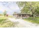 Charming brick home featuring a large front yard and a rustic barn in the background at 156 N Eastern Village Dr, Greenfield, IN 46140