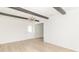 Bright living room with wooden beam ceiling and light hardwood flooring offers a modern aesthetic at 156 N Eastern Village Dr, Greenfield, IN 46140