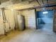 Unfinished basement featuring concrete floor, block walls, exposed ceiling, and a water heater at 1718 Thaddeus St, Indianapolis, IN 46203