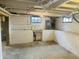 Unfinished basement with concrete floors, block walls, exposed ceiling, sink and windows at 1718 Thaddeus St, Indianapolis, IN 46203