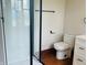 A stylish bathroom featuring an updated tiled shower, toilet, and vanity with modern, neutral accents at 1718 Thaddeus St, Indianapolis, IN 46203