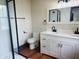 A modern bathroom is equipped with a tiled shower and double vanity for a clean contemporary design at 1718 Thaddeus St, Indianapolis, IN 46203