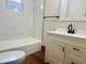 A modern bathroom is equipped with new vanity, black accents, and tiled shower for a clean contemporary design at 1718 Thaddeus St, Indianapolis, IN 46203