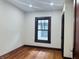 This bedroom offers natural light with a window and has ample space to create a comforting haven at 1718 Thaddeus St, Indianapolis, IN 46203