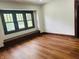 Bright bedroom with hardwood floors, and a window bench providing extra seating and storage at 1718 Thaddeus St, Indianapolis, IN 46203