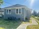 Charming single-story home with gray siding, white trim, and a new sidewalk and foundation at 1718 Thaddeus St, Indianapolis, IN 46203