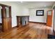 Open-concept living room with hardwood floors, stylish fireplace, and lots of natural light at 1718 Thaddeus St, Indianapolis, IN 46203