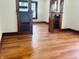 Living room boasting hardwood floors, glass-front cabinets, and an open layout at 1718 Thaddeus St, Indianapolis, IN 46203