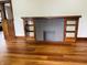 Cozy living room with hardwood floors and built-in fireplace feature with glass cabinets at 1718 Thaddeus St, Indianapolis, IN 46203