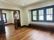 Inviting living room showcasing hardwood floors, built-in cabinets, and natural light from large windows at 1718 Thaddeus St, Indianapolis, IN 46203