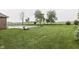 Lush, green backyard featuring a pool and plenty of open space for recreation and relaxation at 1751 S Centennial Ave, New Palestine, IN 46163